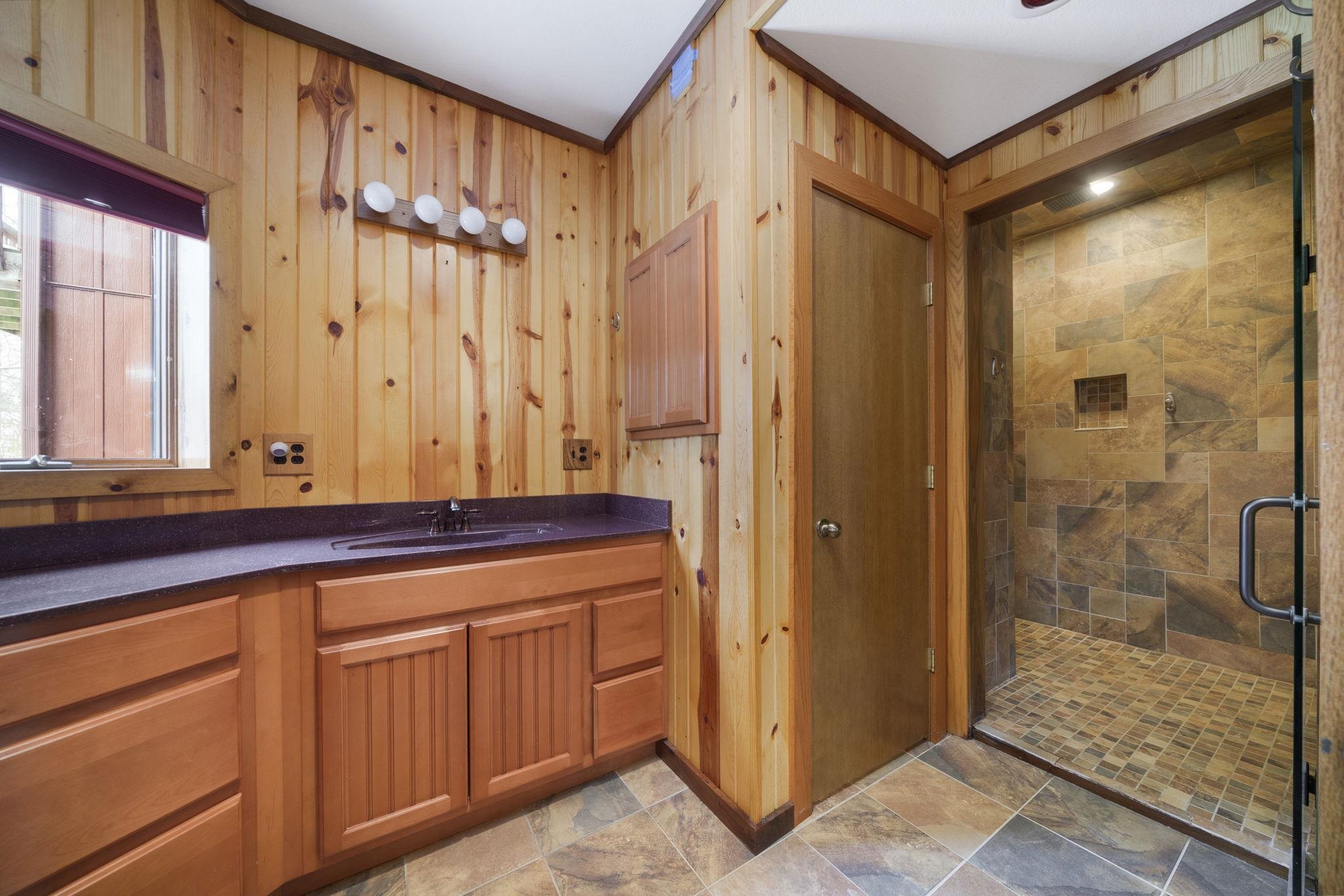 1203 West Mud Creek Road Oregon, IL 61061 - Photo 30 of 67 a bathroom with a granite countertop sink a mirror and shower