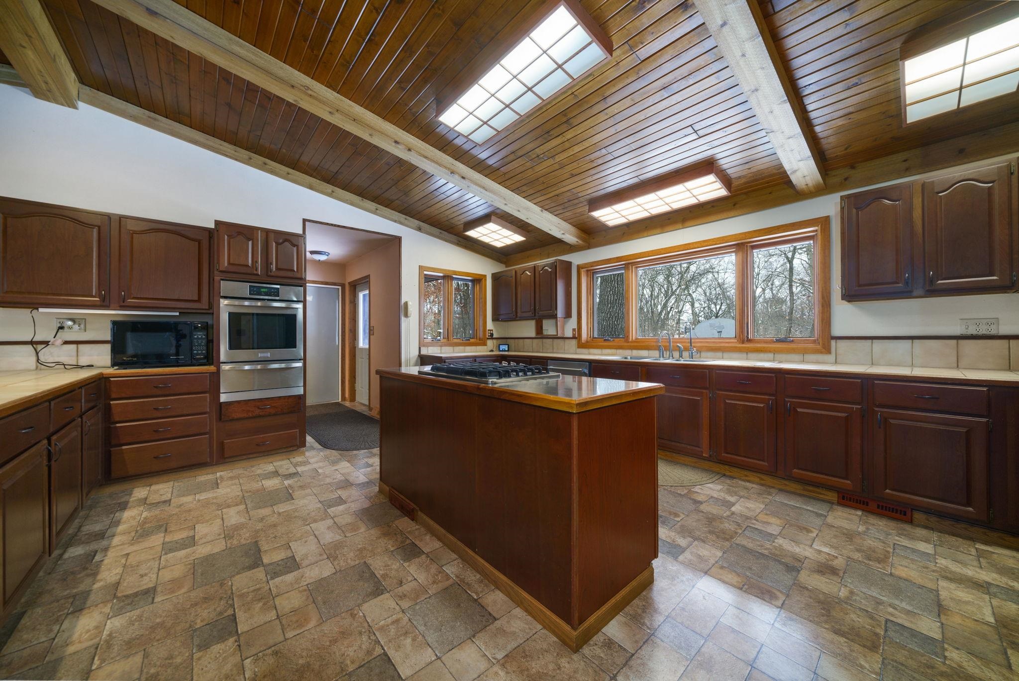 1203 West Mud Creek Road Oregon, IL 61061 - Photo 5 of 67 a kitchen with stainless steel appliances granite countertop a stove a sink and a microwave