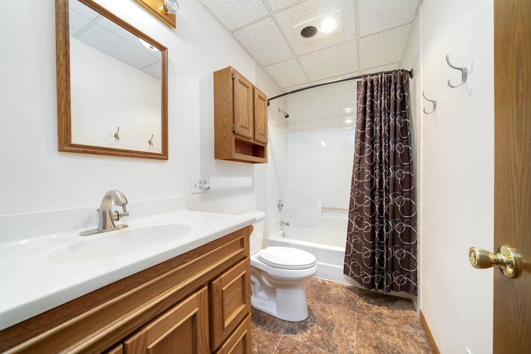 1203 West Mud Creek Road Oregon, IL 61061 - Photo 52 of 67 a bathroom with a sink toilet and shower