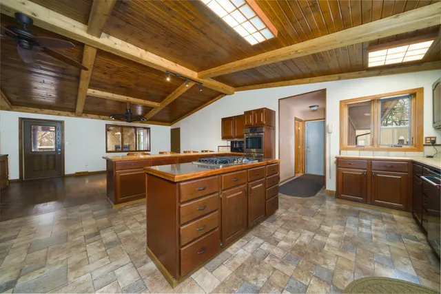 a large kitchen with a large window cabinets and stainless steel appliances