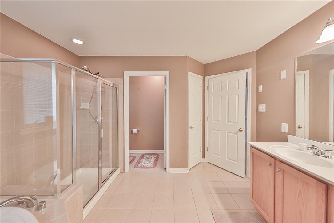 138 Clover Hollow Road Easton, PA 18045 - Photo 47 of 95 Indulge in a tranquil primary bathroom, featuring a glass-enclosed shower and a separate soaking tub.