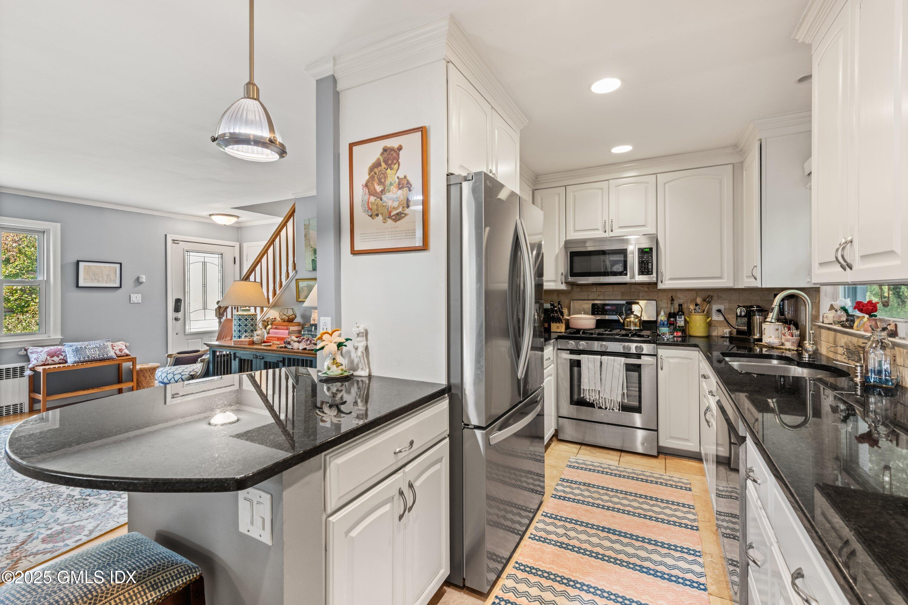 3 Green Lane Greenwich, CT 06831 - Photo 13 of 24 a kitchen with stainless steel appliances kitchen island granite countertop a sink dishwasher stove and refrigerator with wooden floor