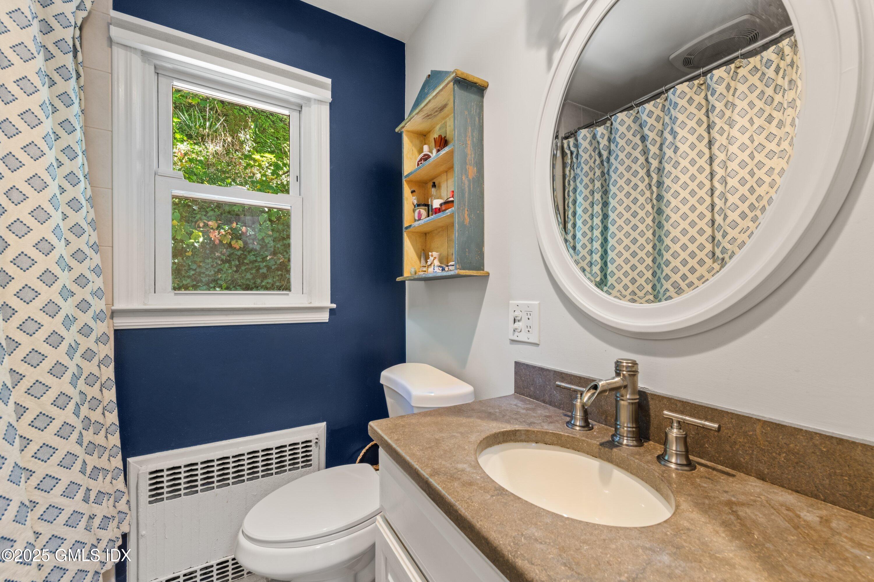 3 Green Lane Greenwich, CT 06831 - Photo 16 of 24 a bathroom with a toilet a sink and a mirror