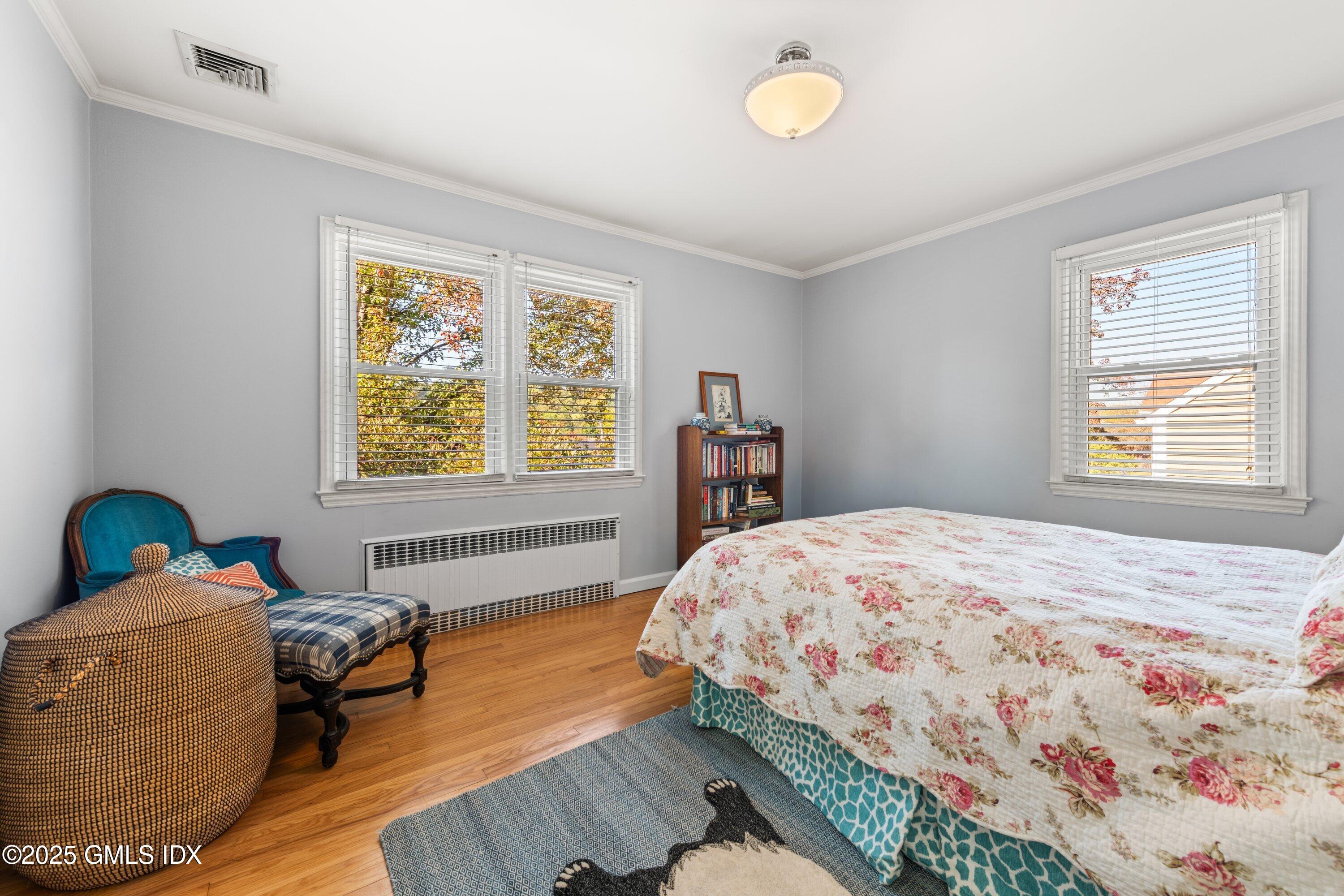 3 Green Lane Greenwich, CT 06831 - Photo 17 of 24 a bedroom with a bed and wooden floor