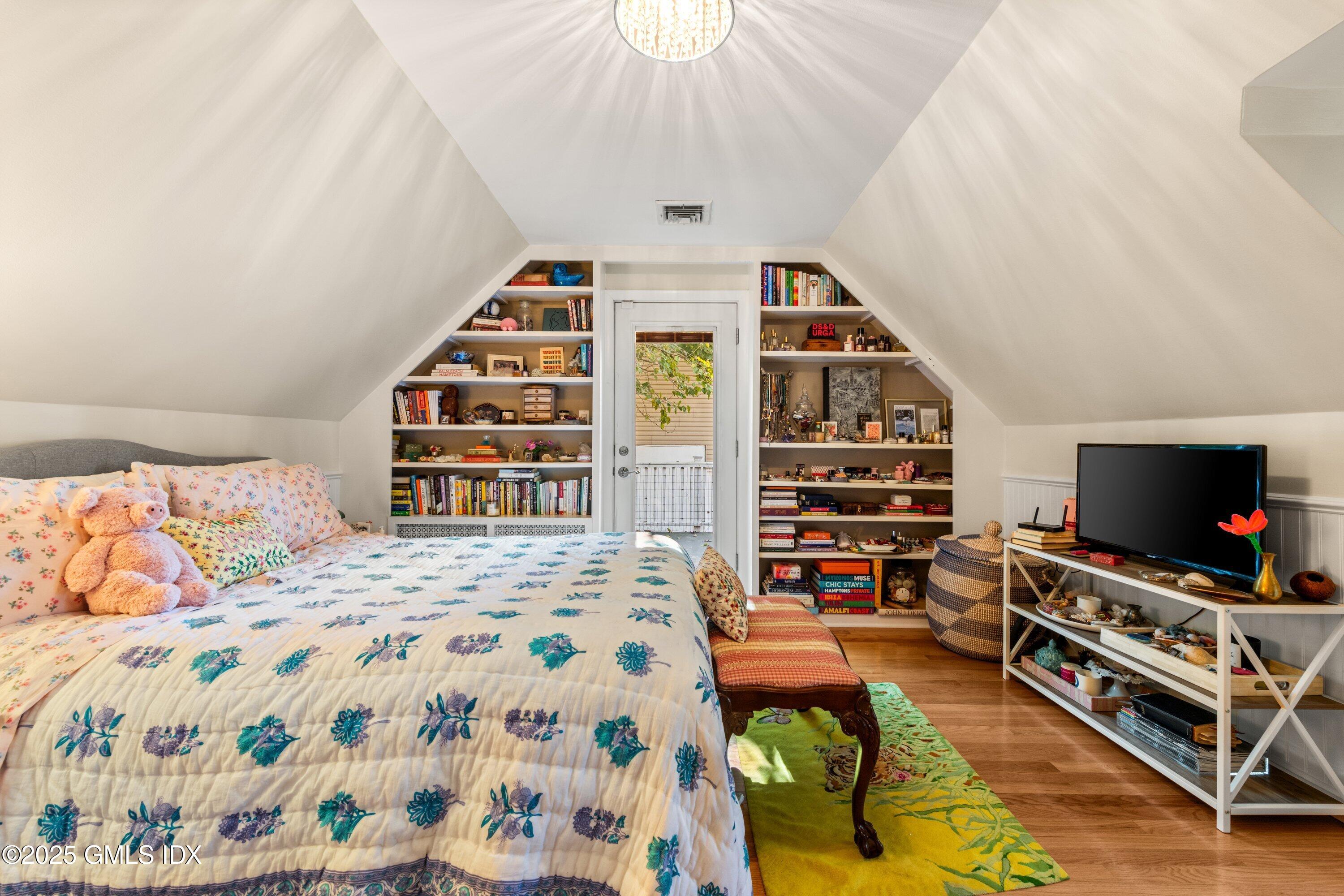 3 Green Lane Greenwich, CT 06831 - Photo 21 of 24 a bedroom with a bed and a bookshelf