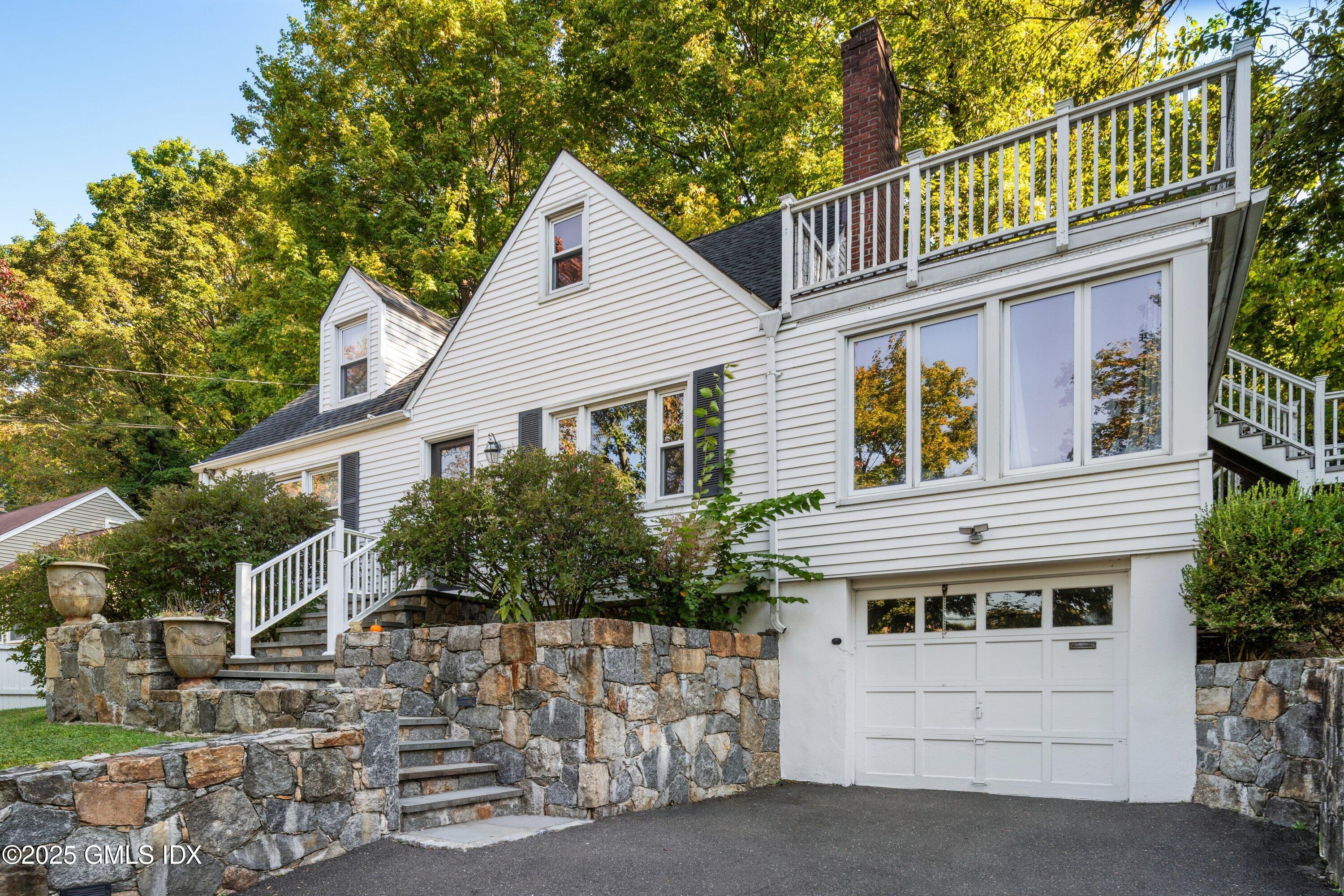 3 Green Lane Greenwich, CT 06831 - Photo 3 of 24 a front view of a house with a garage