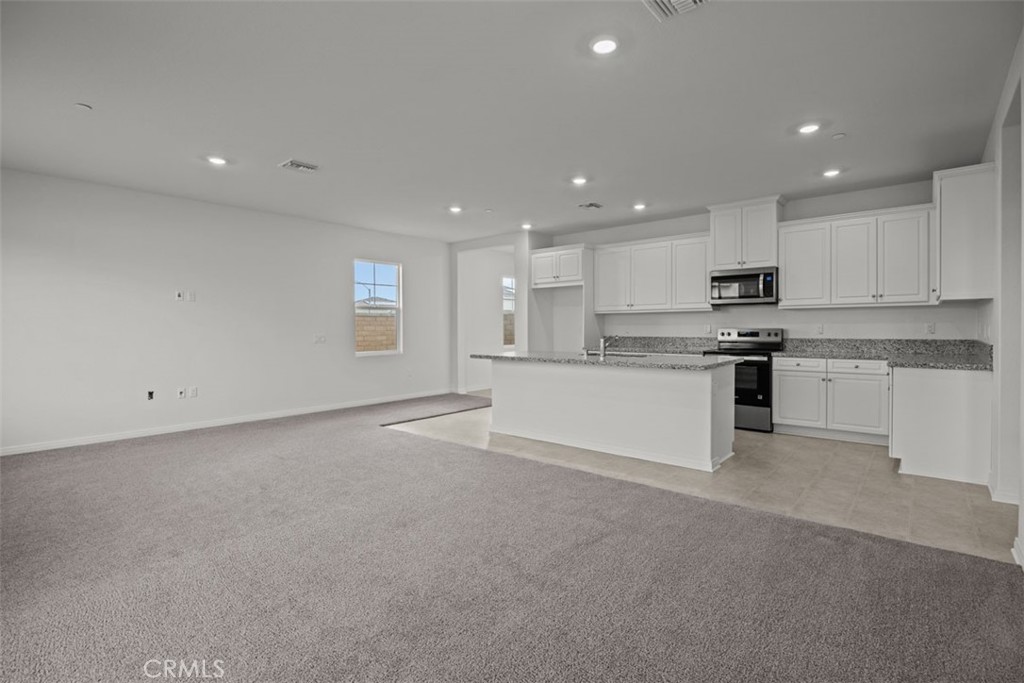25632 Ranch House Road Homeland, CA 92548 - Photo 16 of 26 a open kitchen with white cabinets and stainless steel appliances