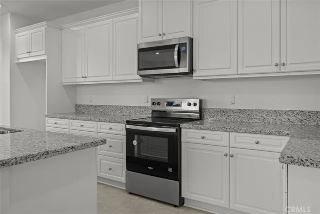 a kitchen with cabinets and stainless steel appliances