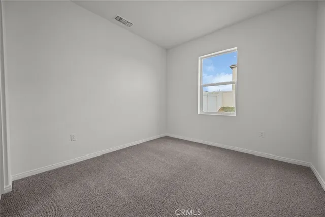 an empty room with closet and mirror