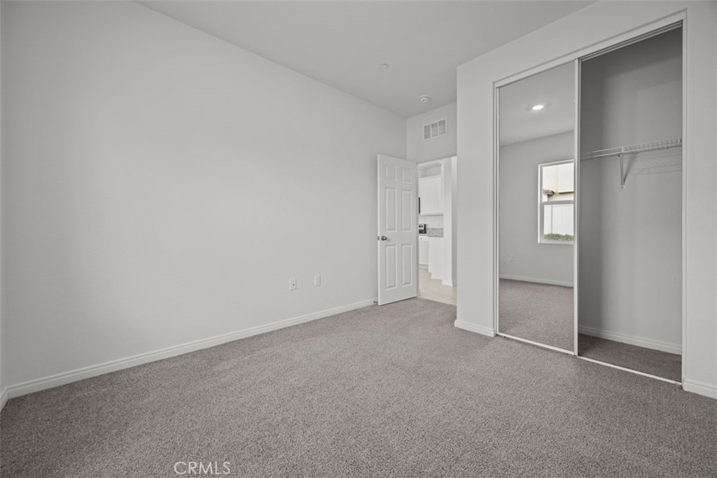 25632 Ranch House Road Homeland, CA 92548 - Photo 23 of 26 an empty room with closet and mirror