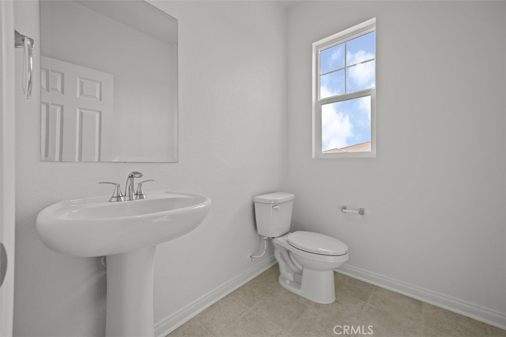 25632 Ranch House Road Homeland, CA 92548 - Photo 24 of 26 a bathroom with a toilet sink and mirror