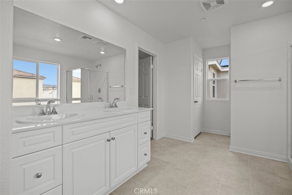 25632 Ranch House Road Homeland, CA 92548 - Photo 10 of 26 a spacious bathroom with a granite countertop sink a mirror and shower