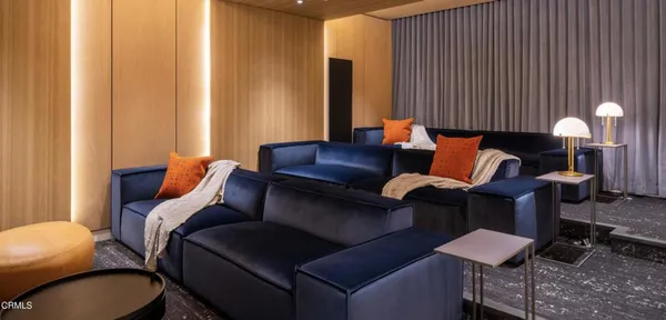a living room with furniture and a lamp