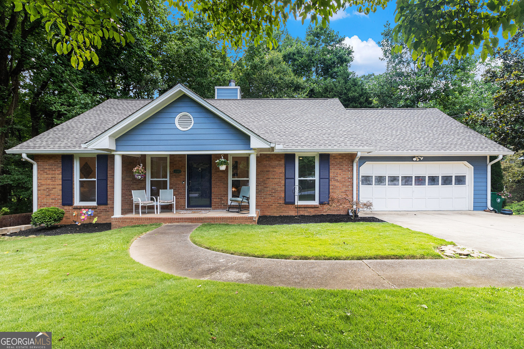 a front view of a house with a yard and porch