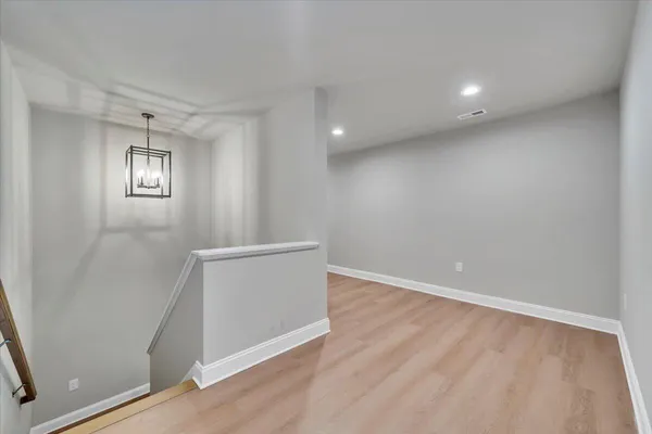a view of balcony with wooden floor and fence