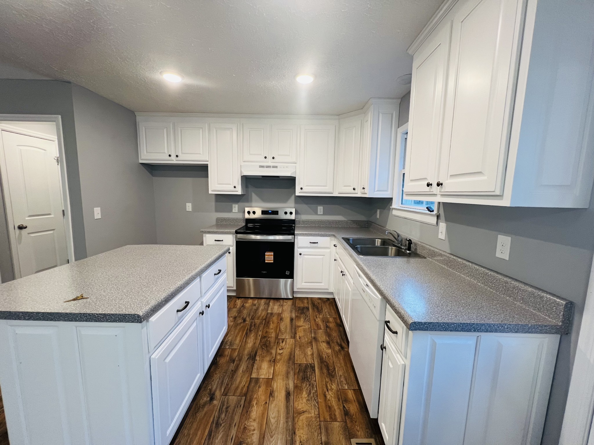 750 Bunker Hill Road Pulaski, TN 38478 - Photo 13 of 36 a kitchen with kitchen island a sink a stove oven a counter space and cabinets