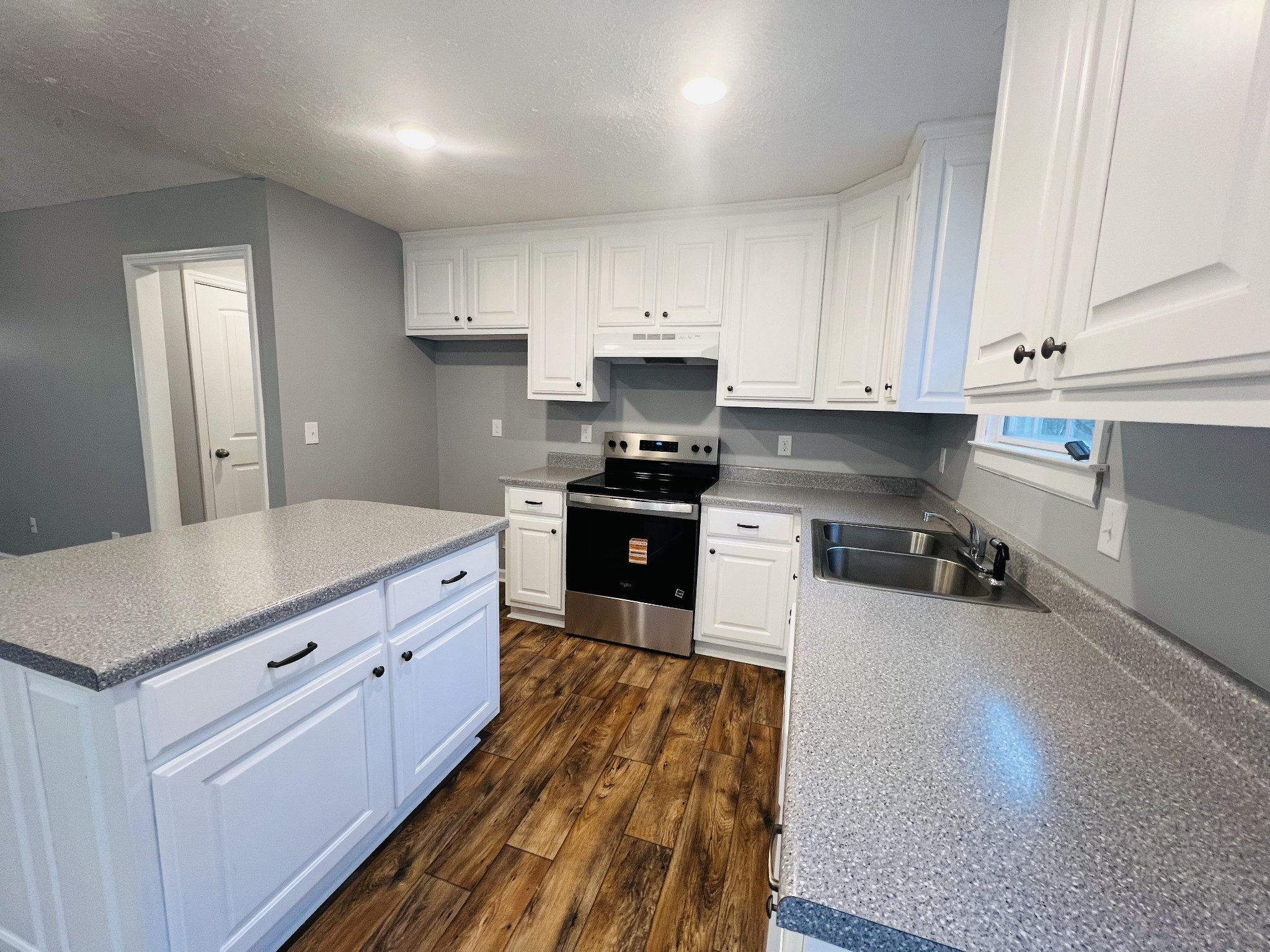 750 Bunker Hill Road Pulaski, TN 38478 - Photo 14 of 36 a kitchen with granite countertop white cabinets and stainless steel appliances