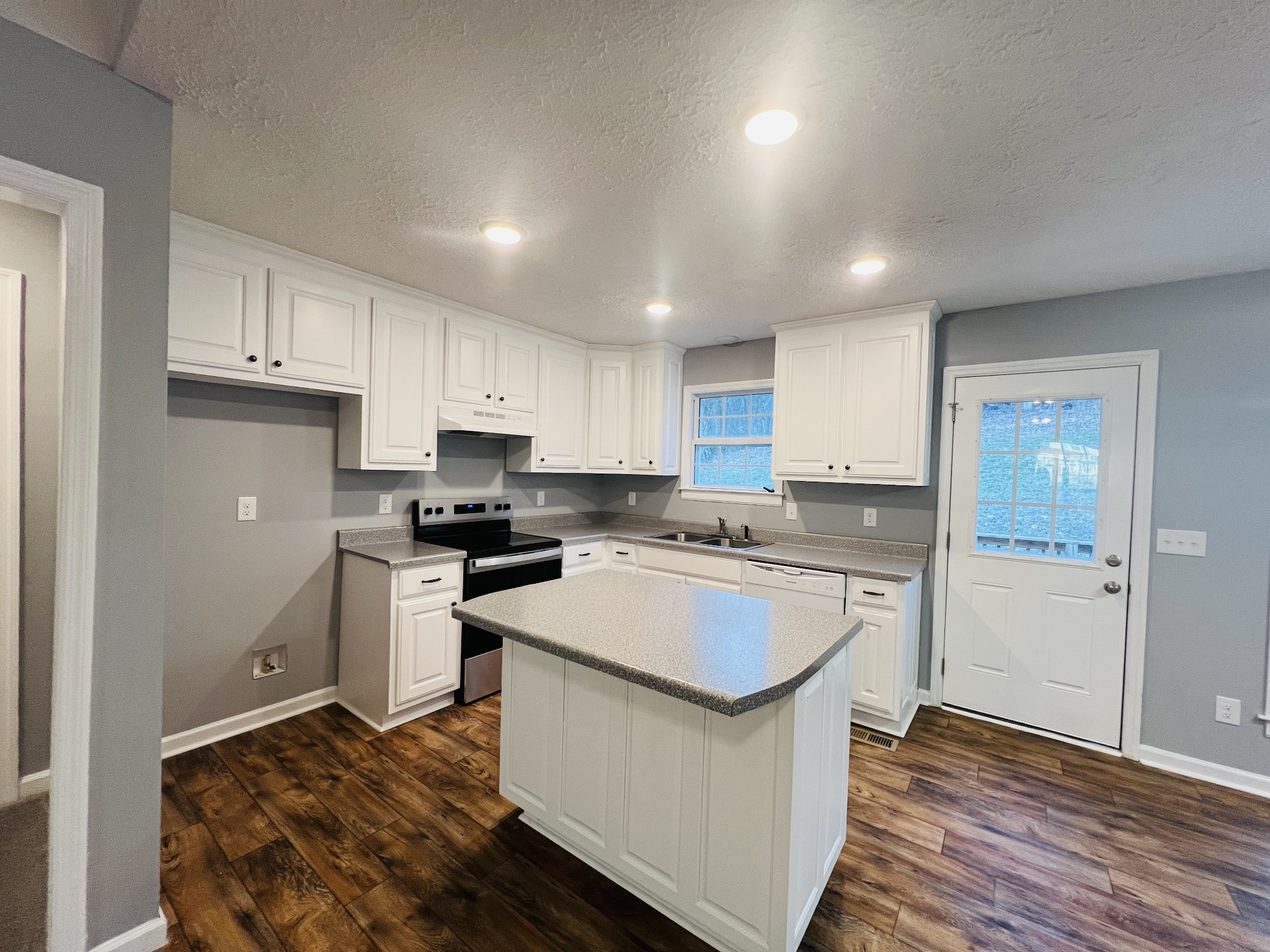 750 Bunker Hill Road Pulaski, TN 38478 - Photo 15 of 36 a kitchen with a sink a stove a refrigerator and white cabinets
