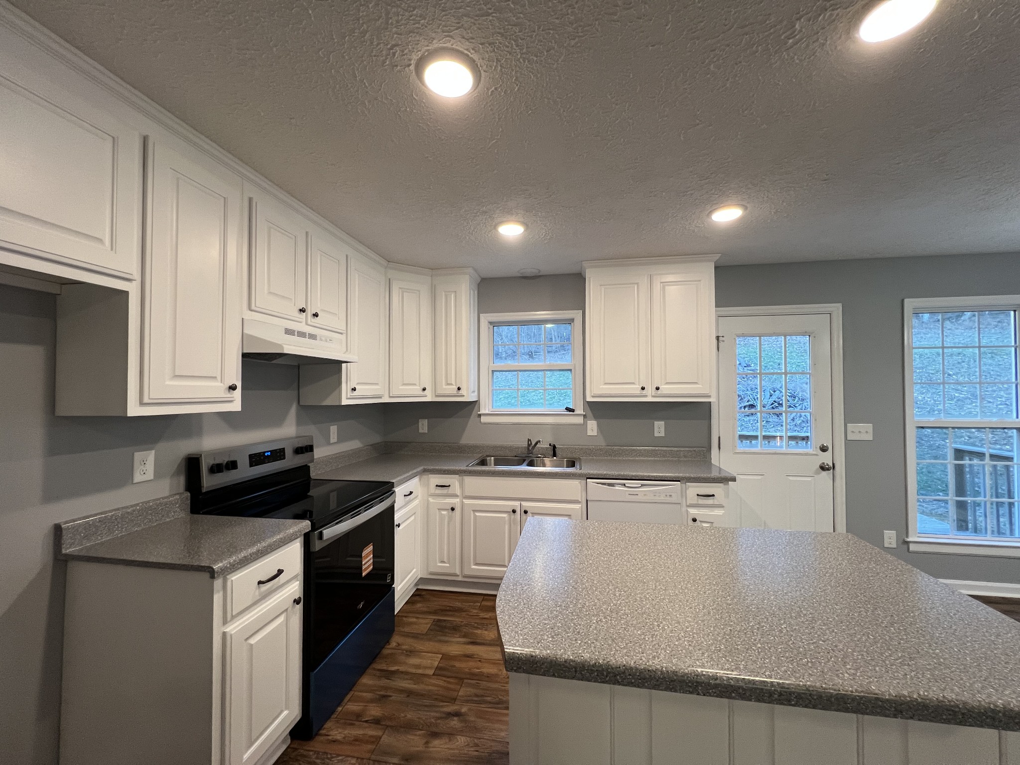750 Bunker Hill Road Pulaski, TN 38478 - Photo 25 of 36 a large kitchen with stainless steel appliances granite countertop a stove a sink a refrigerator and white cabinets