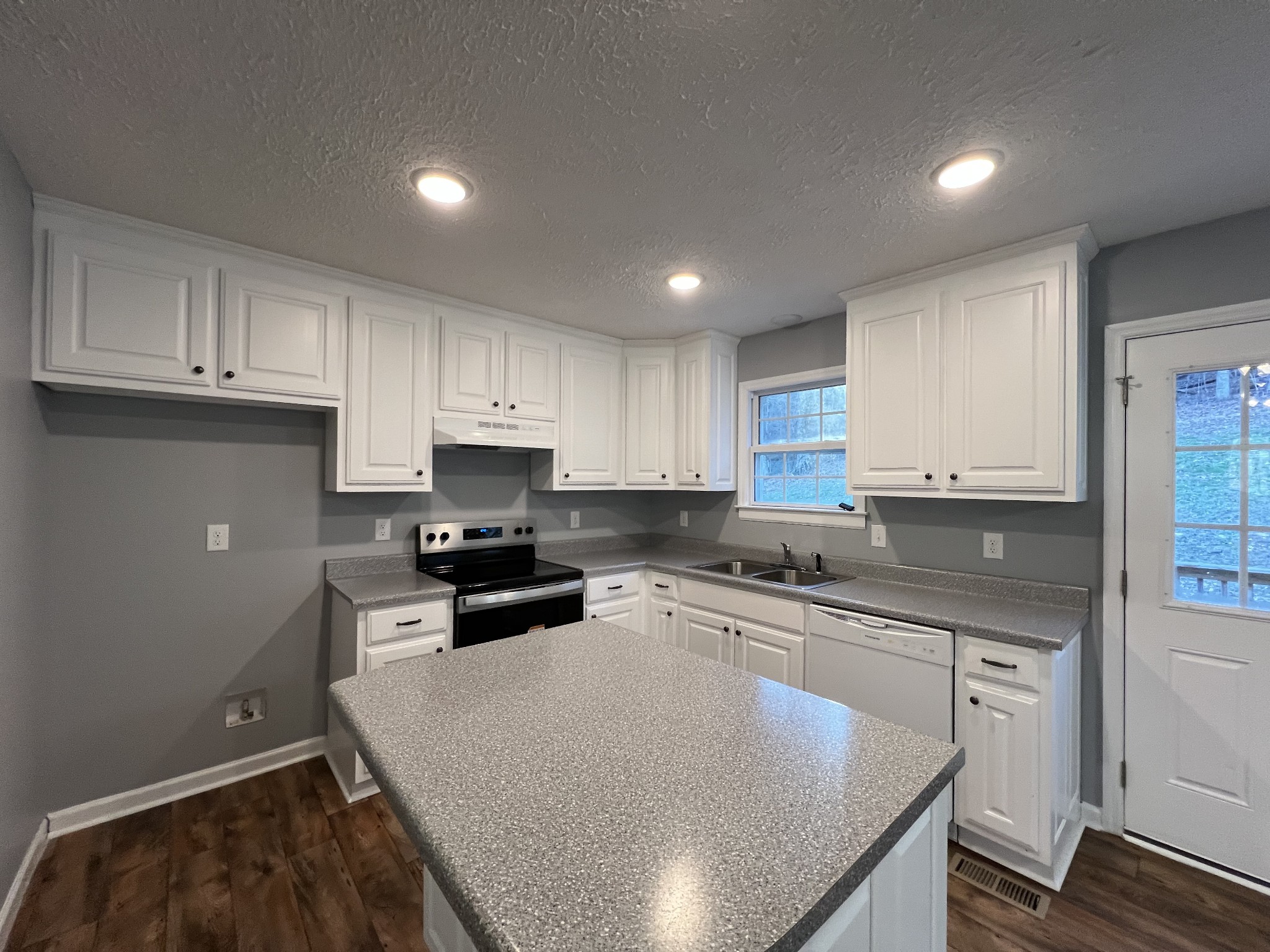 750 Bunker Hill Road Pulaski, TN 38478 - Photo 26 of 36 a kitchen with granite countertop a sink stove and cabinets