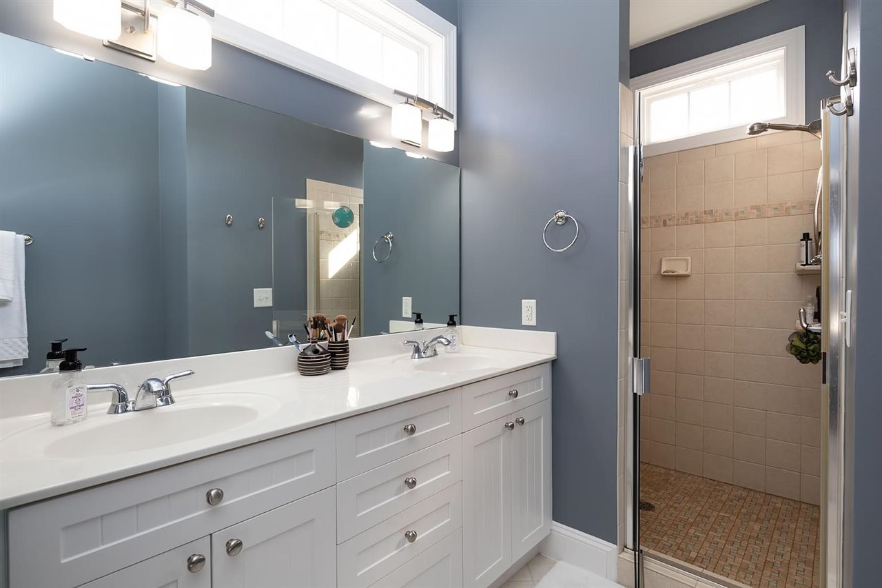 1112 Harp Street Raleigh, NC 27604 - Photo 13 of 25 a bathroom with a double vanity sink and mirror