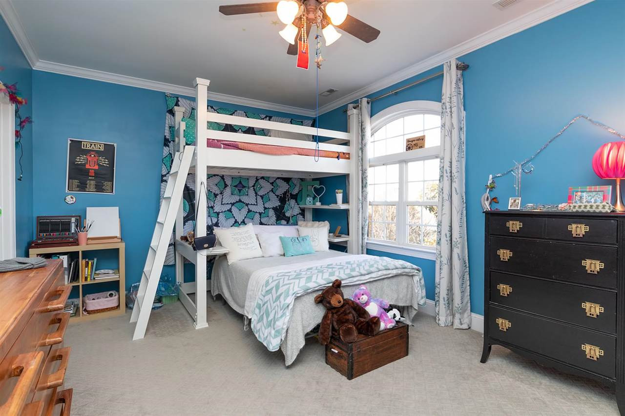 1112 Harp Street Raleigh, NC 27604 - Photo 14 of 25 a bedroom with a bed and a chandelier