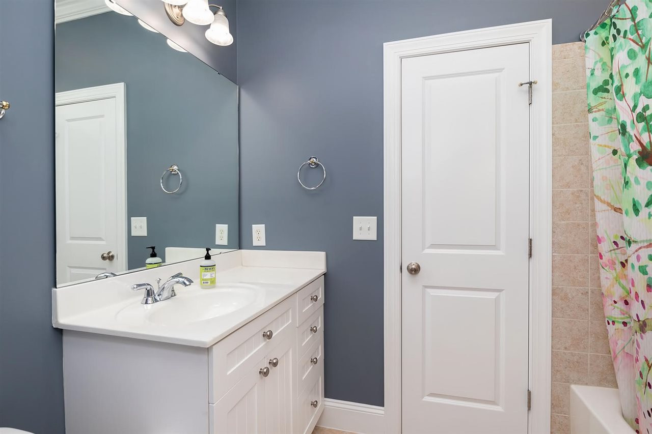 1112 Harp Street Raleigh, NC 27604 - Photo 15 of 25 a bathroom with a sink and a mirror