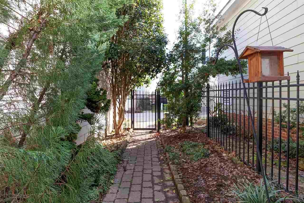 1112 Harp Street Raleigh, NC 27604 - Photo 18 of 25 a view of a backyard with brick wall and potted plants