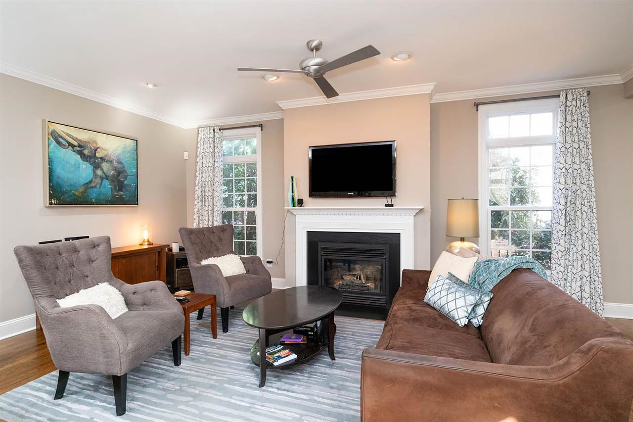 1112 Harp Street Raleigh, NC 27604 - Photo 4 of 25 a living room with furniture a fireplace and a flat screen tv