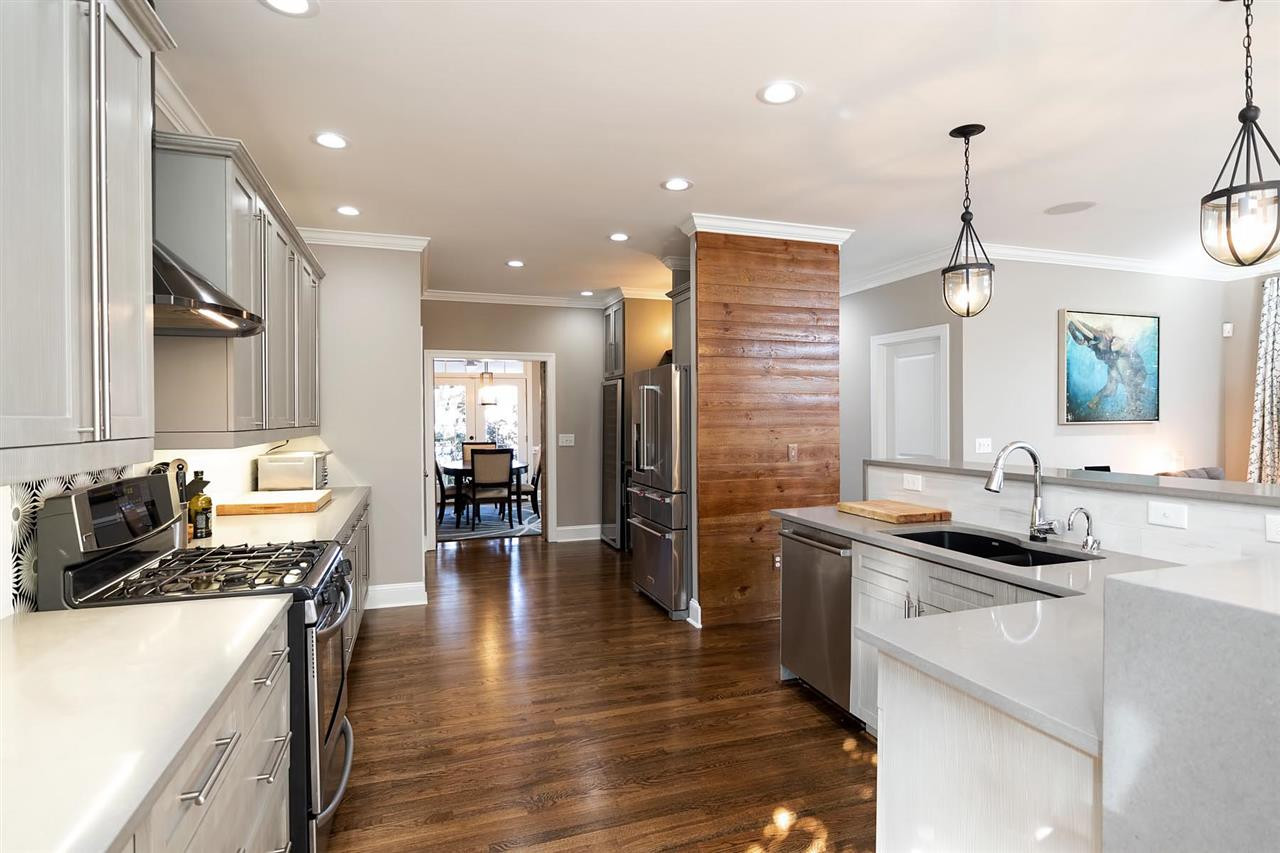1112 Harp Street Raleigh, NC 27604 - Photo 7 of 25 a kitchen with stainless steel appliances granite countertop a sink stove and refrigerator