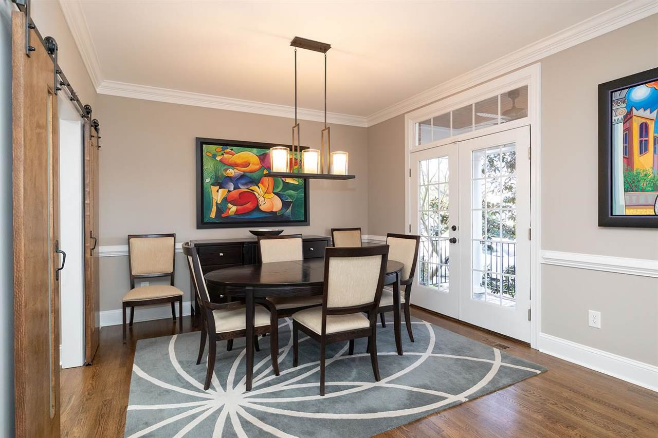 1112 Harp Street Raleigh, NC 27604 - Photo 10 of 25 a dining room with furniture a rug a potted plant and wooden floor