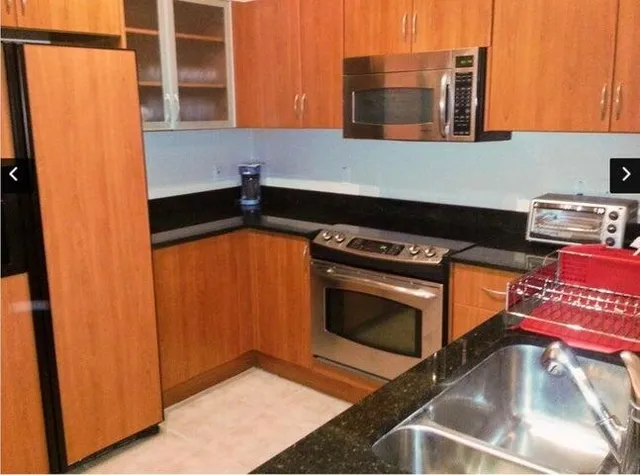 a kitchen with stainless steel appliances granite countertop a stove and a microwave