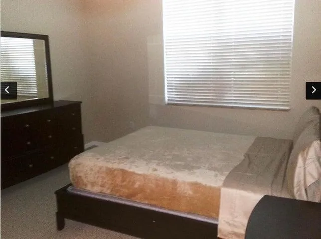 a room with a bed and a dresser
