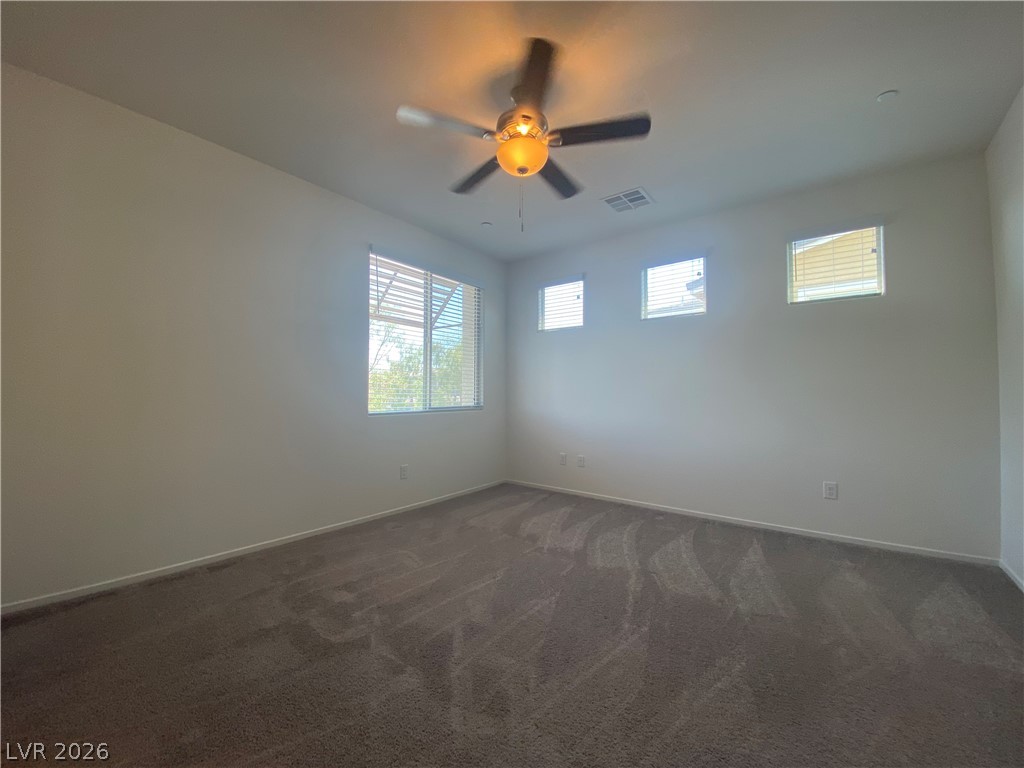 436 Cadence View Way Henderson, NV 89011 - Photo 17 of 36 Well-lit room provides a neutral canvas for personalization, complete with a modern ceiling fan.