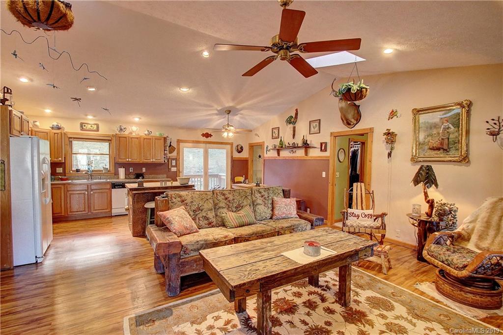 951 Price Town Road Clyde, NC 28721 - Photo 6 of 36 a living room with lots of furniture and kitchen view