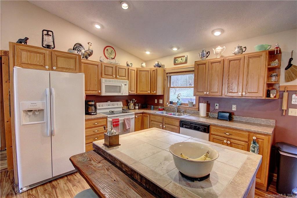 951 Price Town Road Clyde, NC 28721 - Photo 7 of 36 a large kitchen with a large window and stainless steel appliances