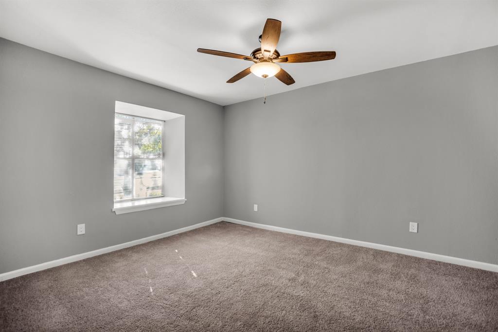 13769 Brookgreen Circle Dallas, TX 75240 - Photo 12 of 18 an empty room with a window and a fan