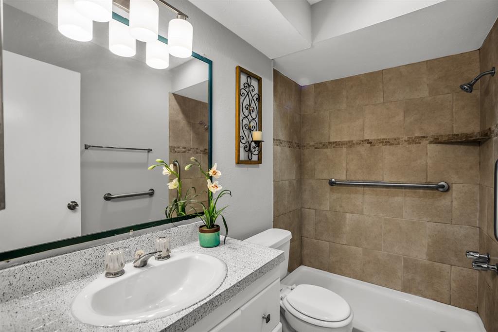 13769 Brookgreen Circle Dallas, TX 75240 - Photo 14 of 18 a bathroom with a sink toilet and shower