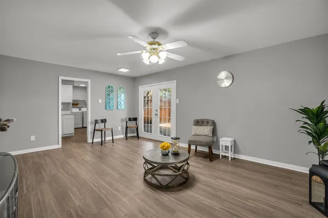a living room with furniture and wooden floor