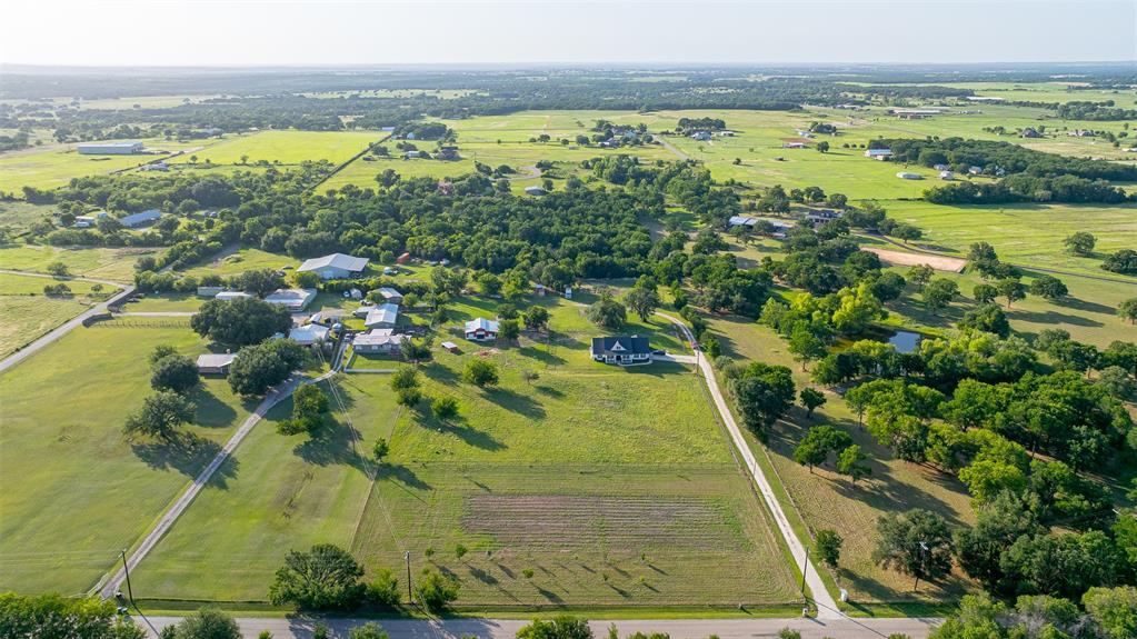 1920 Meander Road Granbury, TX 76049 - Photo 34 of 40 Expansive rural property featuring a large residence, meandering driveways, and mature trees