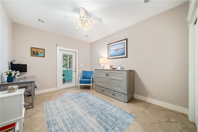 a living room with furniture and paintings on the wall