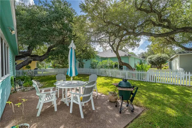 a view of a table and chairs in patio with a yard