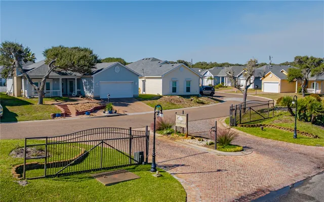 an aerial view of a house with swimming pool and a yard