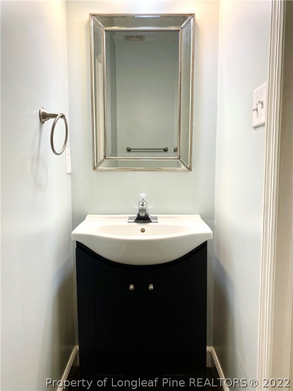 407 Larchmont Road Fayetteville, NC 28311 - Photo 7 of 16 a bathroom with a sink and a mirror