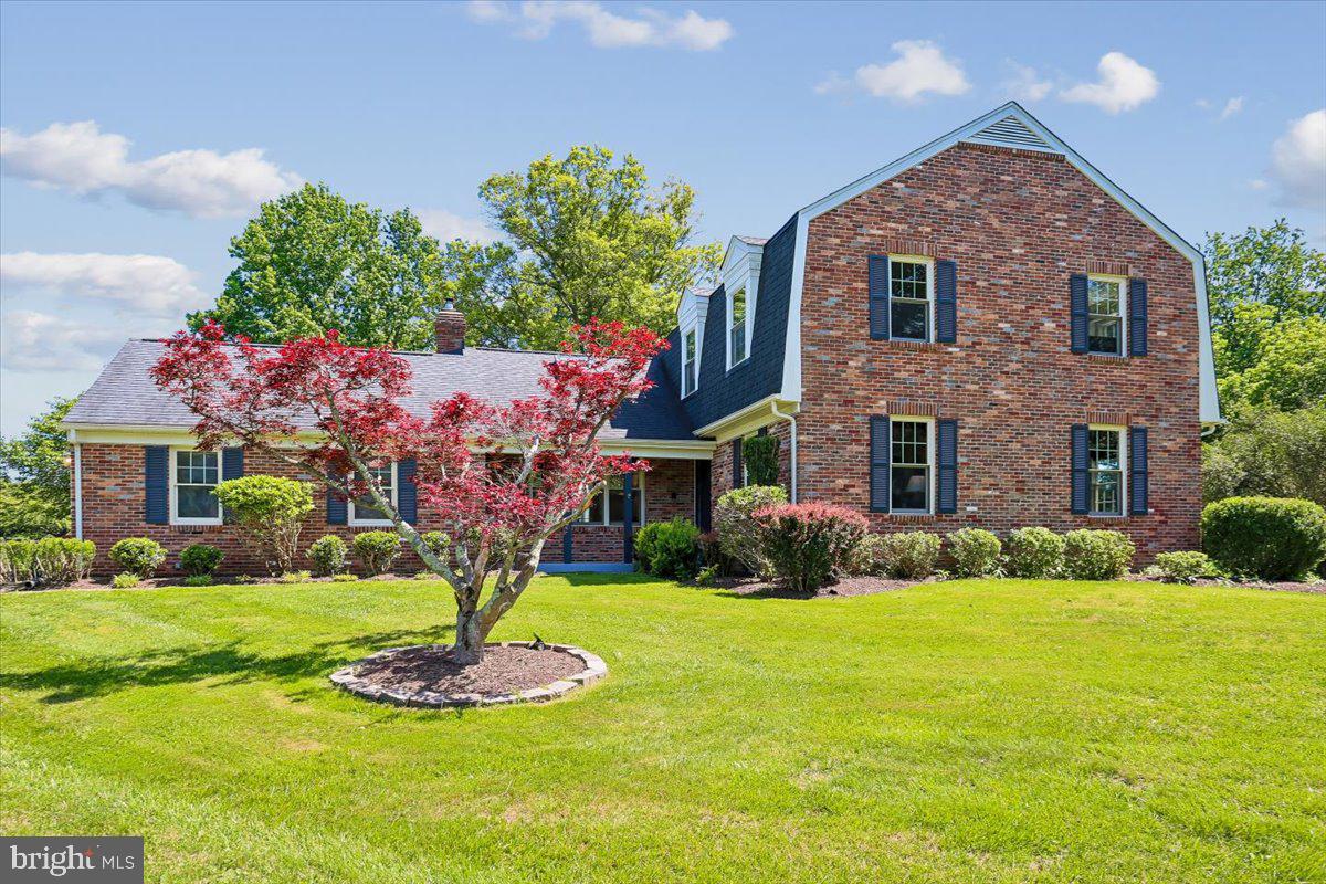 Renovated brick colonial with side load garage