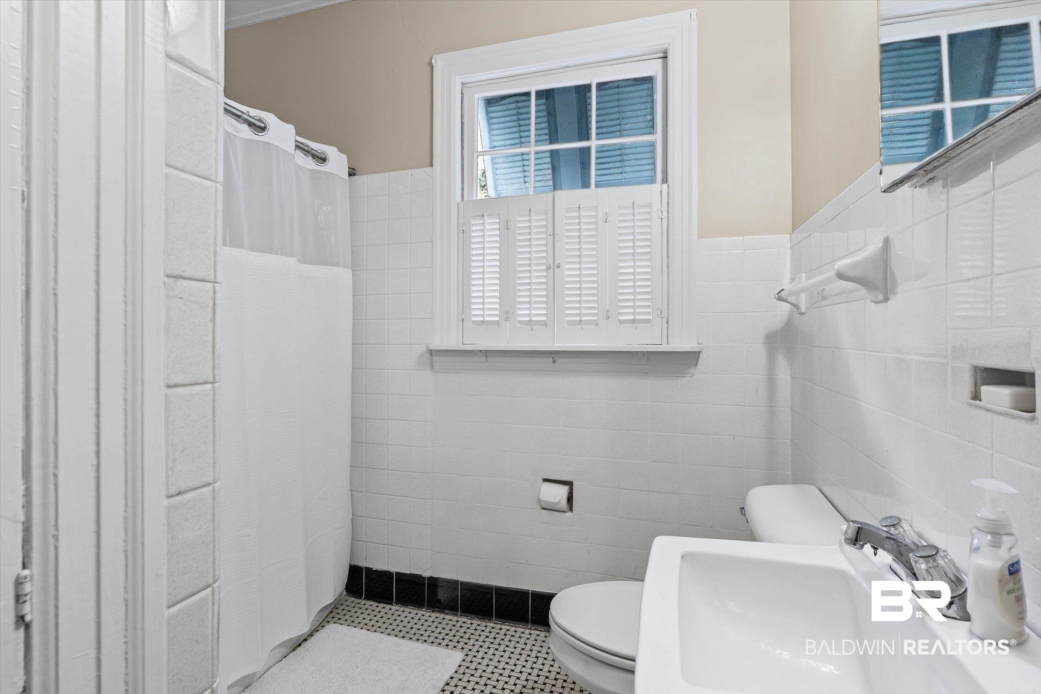 7015 Bay Road Mobile, AL 36605 - Photo 36 of 53 Guest Cottage- Full bathroom featuring a shower with shower curtain, tile walls, and dark tile patterned flooring