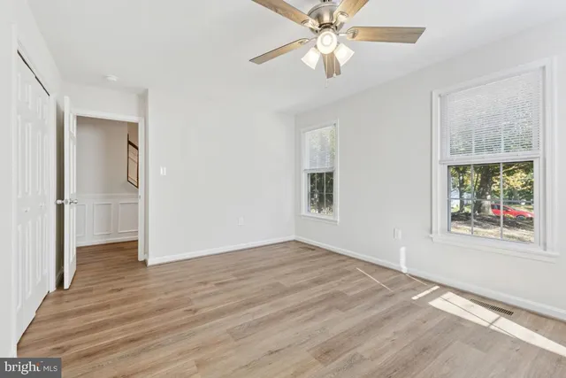 wooden floor in an empty room with a window