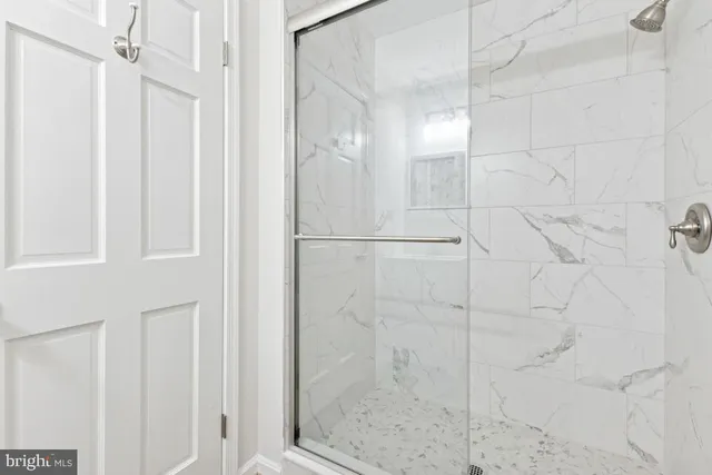a bathroom with a glass shower door