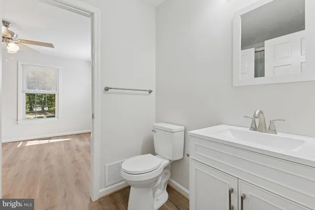 a bathroom with a sink a toilet and a mirror