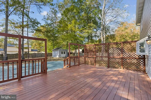 a view of a deck with wooden floor and fence